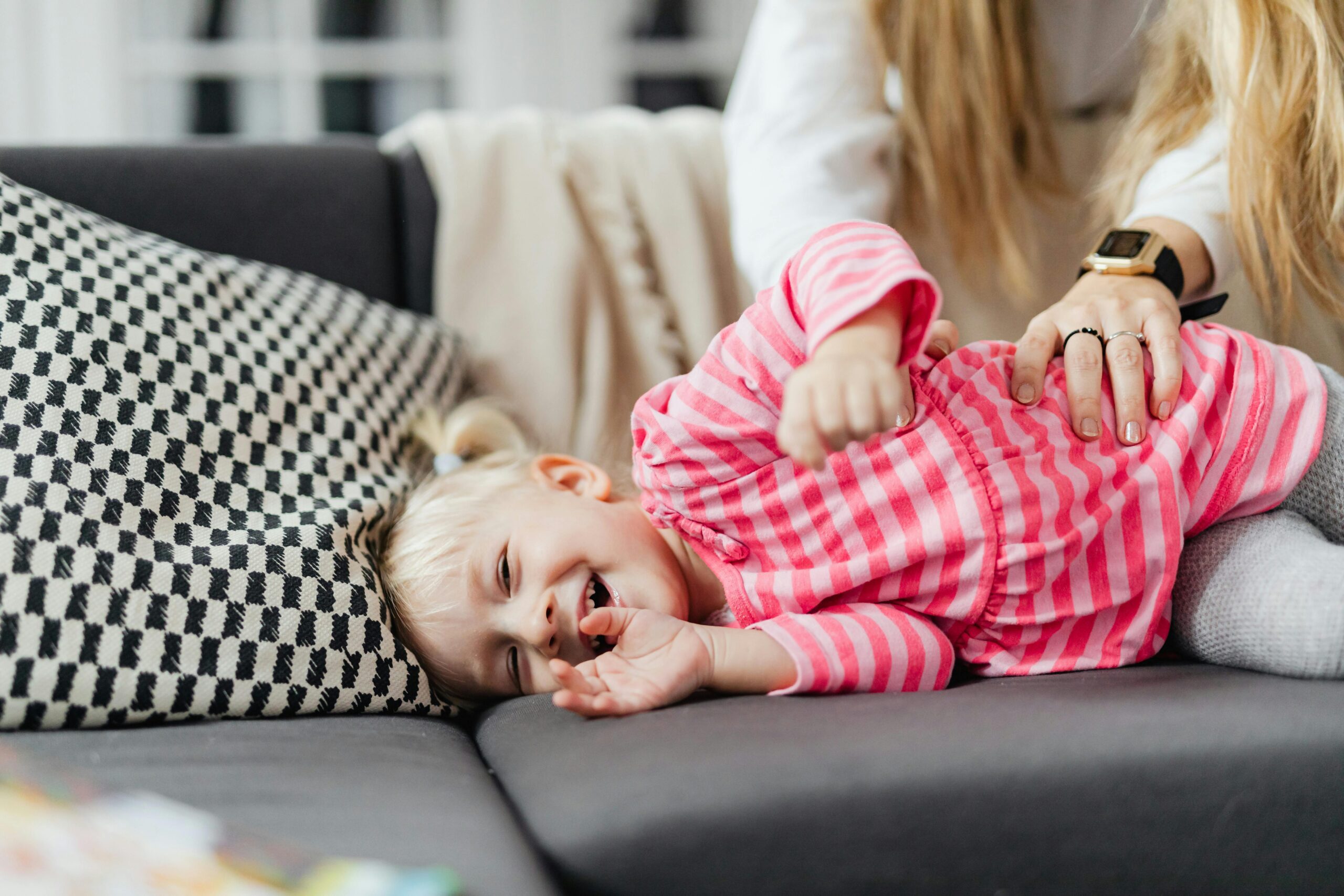 person laughing from being tickled illustrating the tickle response