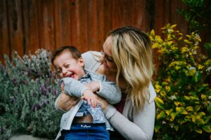 parent and child laughing during tickle play